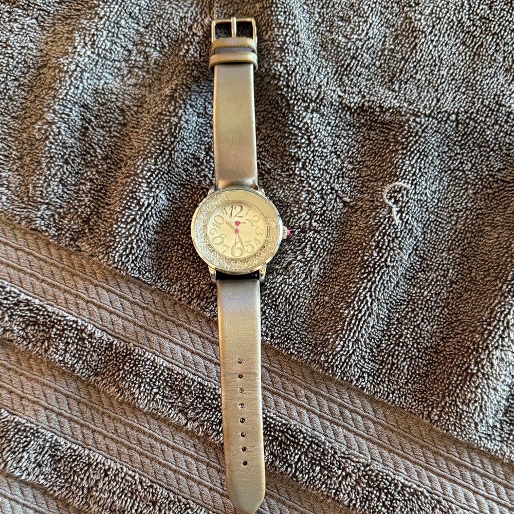 Betsey Johnson Women’s Silver Leather Watch with Silver and pink accents.